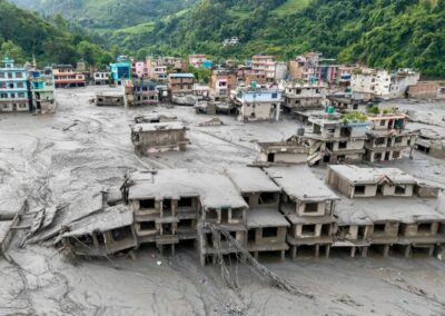 Aerial view of a Nepali village submerged in mud after the August 2026 floods