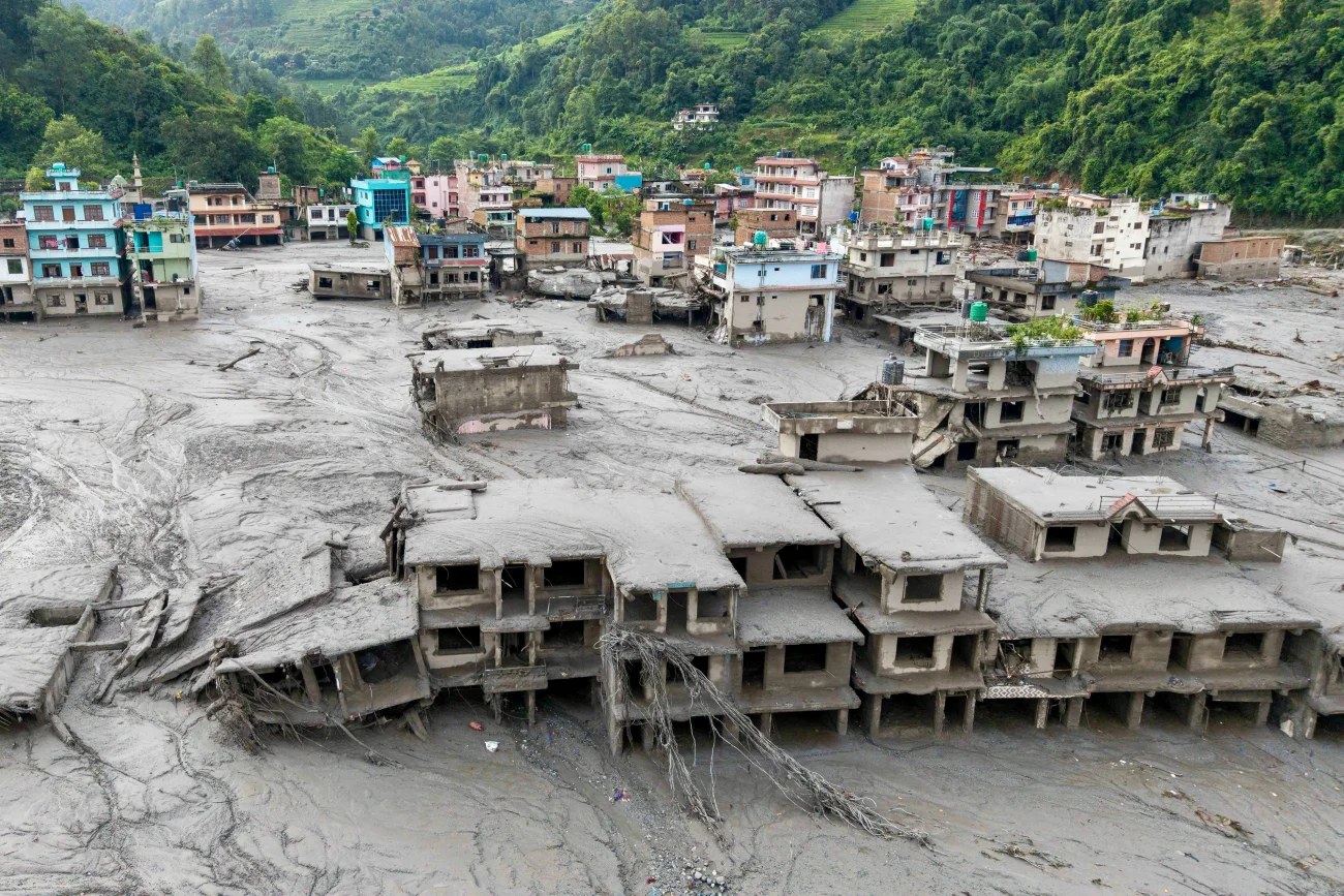 Aerial view of a Nepali village submerged in mud after the August 2026 floods